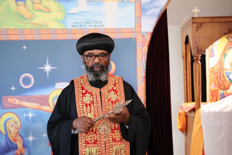 A priest holding the hand cross
